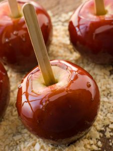 Toffee Apples on Crushed Toasted Almonds On Wooden Table